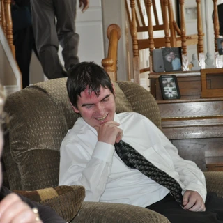 Alex smiling on the couch