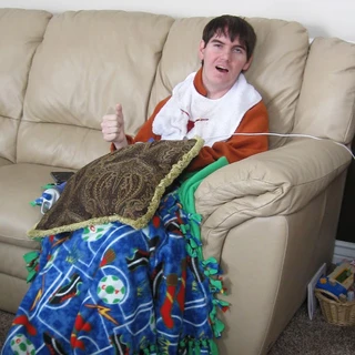 Alex wearing a Texas bib giving a thumbs up