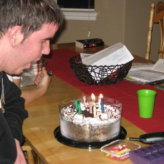 Alex blowing out candles on his birthday cake