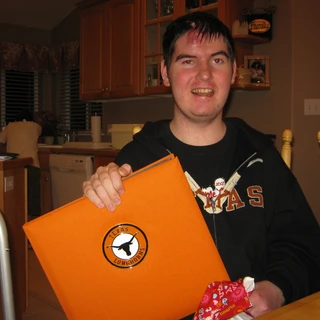Alex holding his Texas photo album