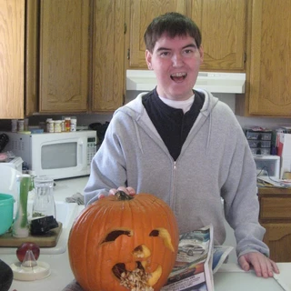 Alex carving a pumpkin