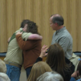 Alex at his eagle court of honor hugging Mom