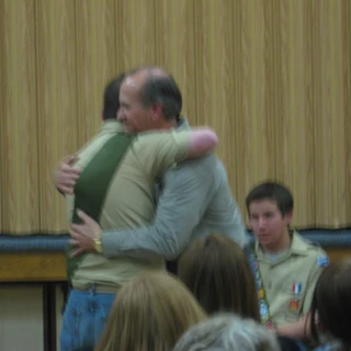 Alex at his eagle court of honor giving Dad a hug