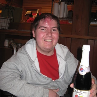 Alex holding a bottle of martinelli