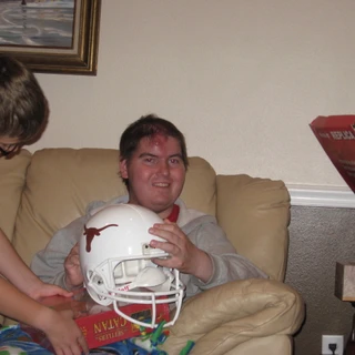 Alex holding a Texas football helmet