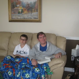 Alex sitting on the couch with Josh