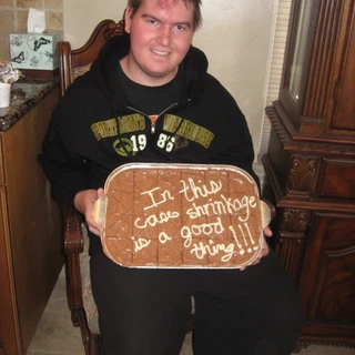 Alex holding his cake at his tumor shrinking party