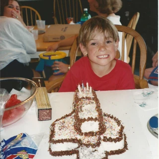 Alex with a rocketship birthday cake