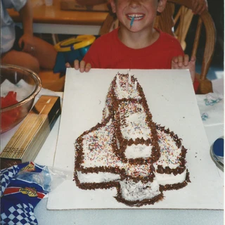 Alex with a rocketship birthday cake (2)