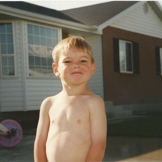 Alex shirtless in the neighbors driveway