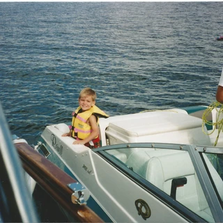 Alex on the back of a boat