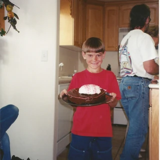 Alex holding his baseball birthday cake