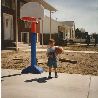 Alex playing basketball in the driveway
