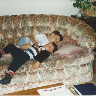 Alex and Chris sleeping on the couch
