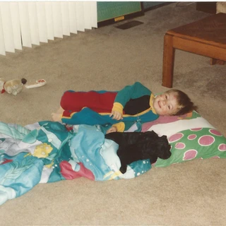 Alex laying down with puppies