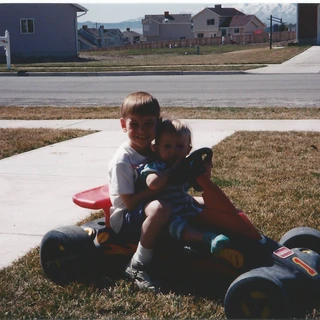 Alex and Nicole driving a racecar