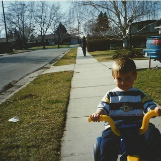 Alex riding a tricycle