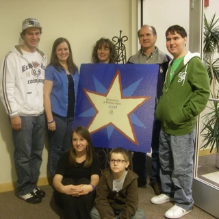 Family photo at Make A Wish Welcome sign