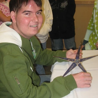 Alex holding his Make A Wish star