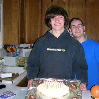 Alex and Chris holding a birthday cake