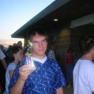 Alex holding a soccer trophy