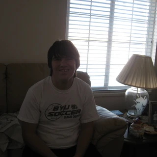 Alex smiling on the couch