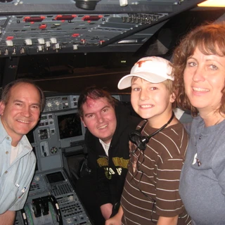 Alex, dad, Josh, and mom in the cockpit of the plane