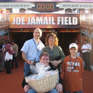 Alex, mom, dad, and Josh at the entrance of the field