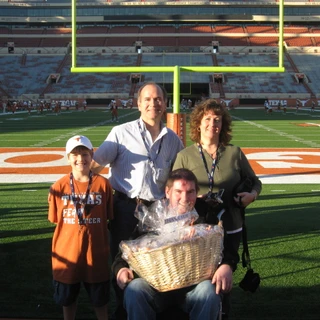 Alex, mom, dad, and Josh on the football field