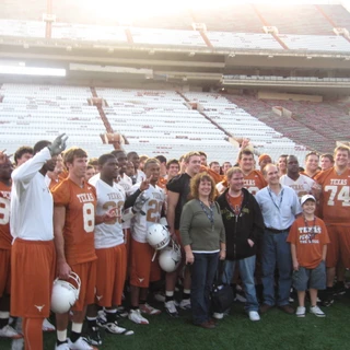Alex, mom, dad, and Josh with the Texas footbal team
