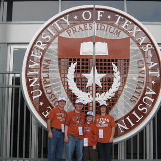 Alex, Mom, Dad, and Josh at UT entrance