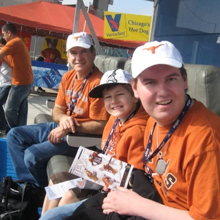 Alex, Josh, and Dad in the stands at the stadium