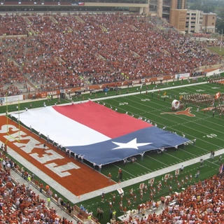 Texas Football field with the flag and band