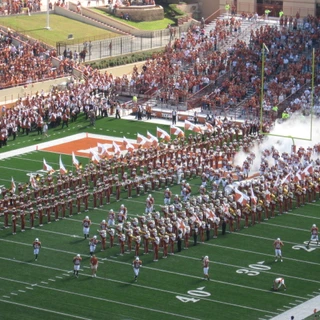 Texas football team running onto the field