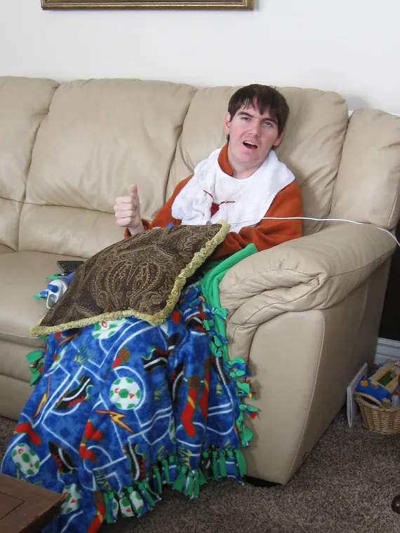 Alex wearing a Texas bib giving a thumbs up