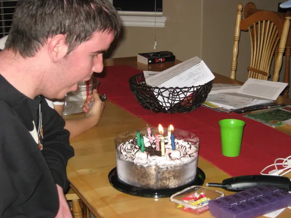 Alex blowing out candles on his birthday cake