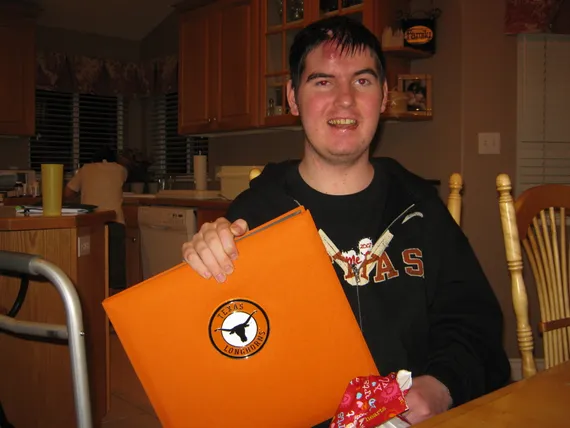 Alex holding his Texas photo album