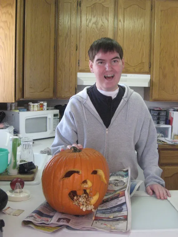 Alex carving a pumpkin