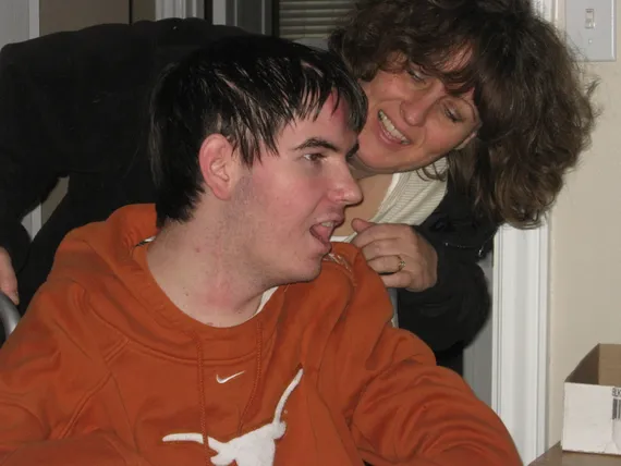 Mom wheeling Alex into his Texas room