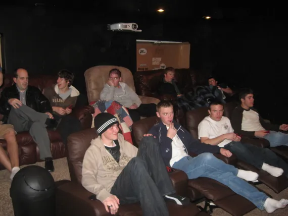 Alex with the young men in the theater room