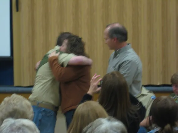 Alex at his eagle court of honor hugging Mom