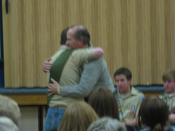 Alex at his eagle court of honor giving Dad a hug