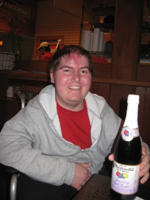 Alex holding a bottle of martinelli