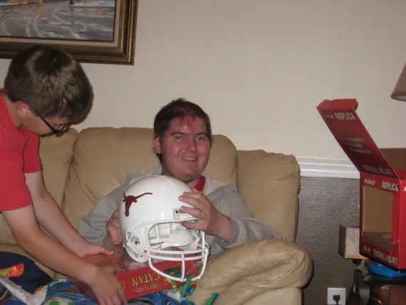 Alex holding a Texas football helmet