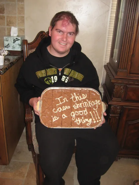 Alex holding his cake at his tumor shrinking party