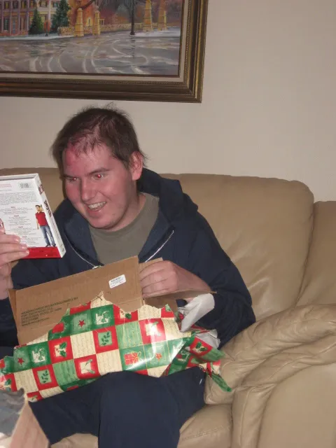 Alex opening a Christmas present