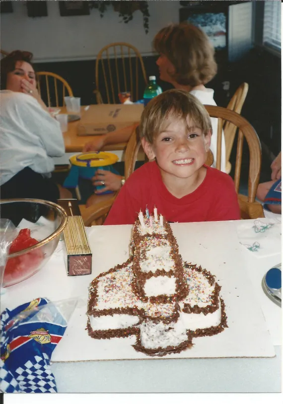 Alex with a rocketship birthday cake