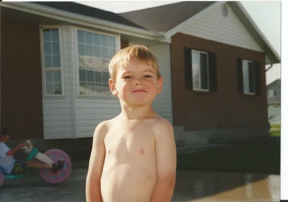 Alex shirtless in the neighbors driveway