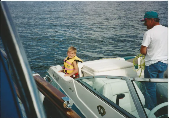 Alex on the back of a boat