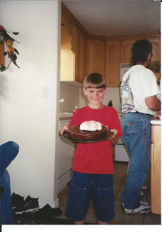 Alex holding his baseball birthday cake